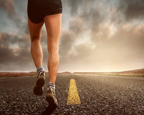 Runners legs on track healthy lifestyle